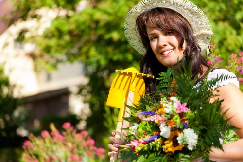 Professional garden clearance team collecting leaves and debris in Surbiton